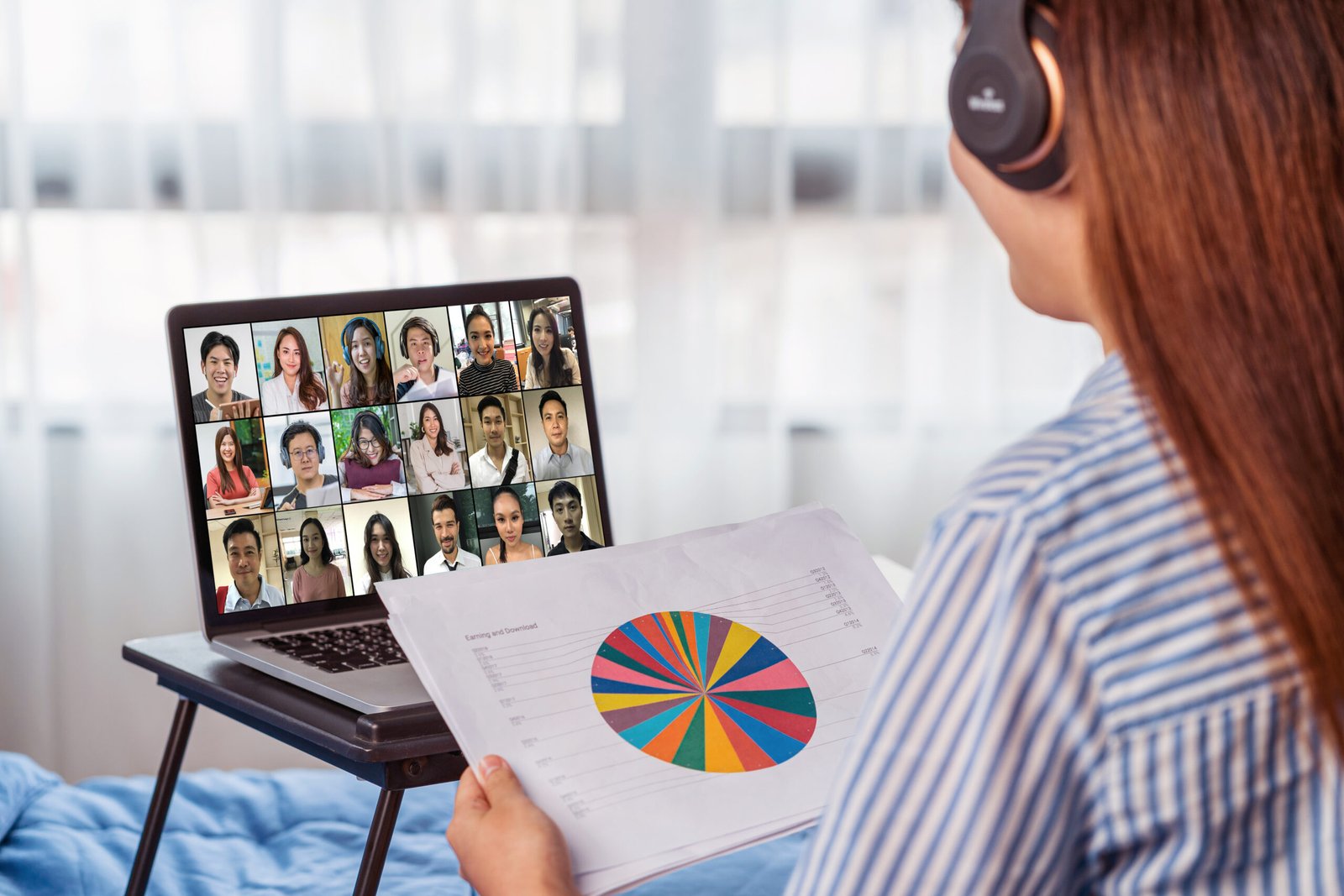 Rear view of Asian woman working and online meeting via video conference with colleague and team building when Covid-19 pandemic,Coronavirus outbreak,education and Social distancing,new normal concept